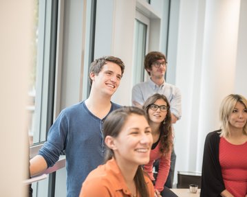 Smiling business psychology students during the lecture in Berlin